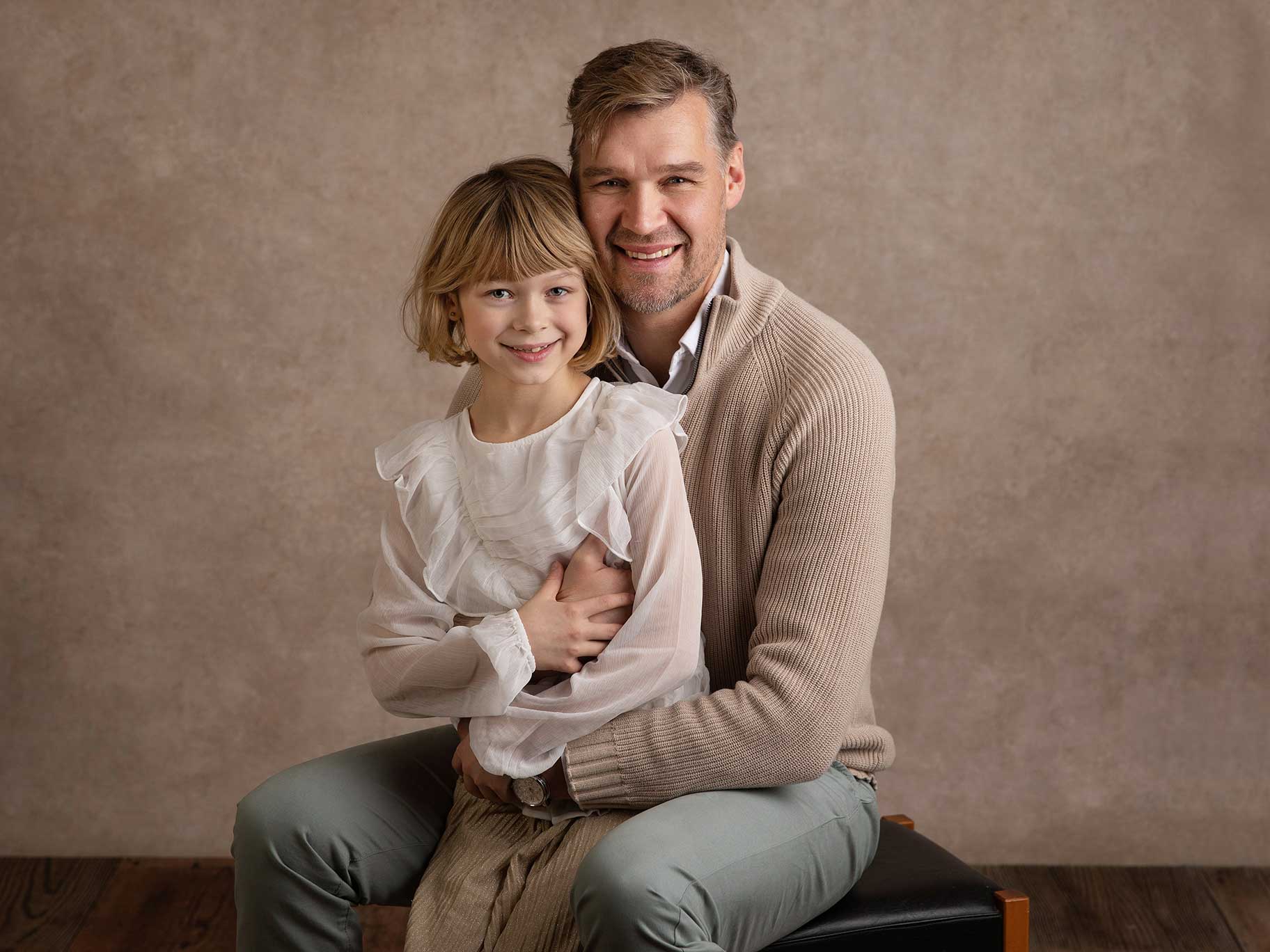 Pappa blir fotograferad med sin dotter i famnen under fotosession i Malmö.