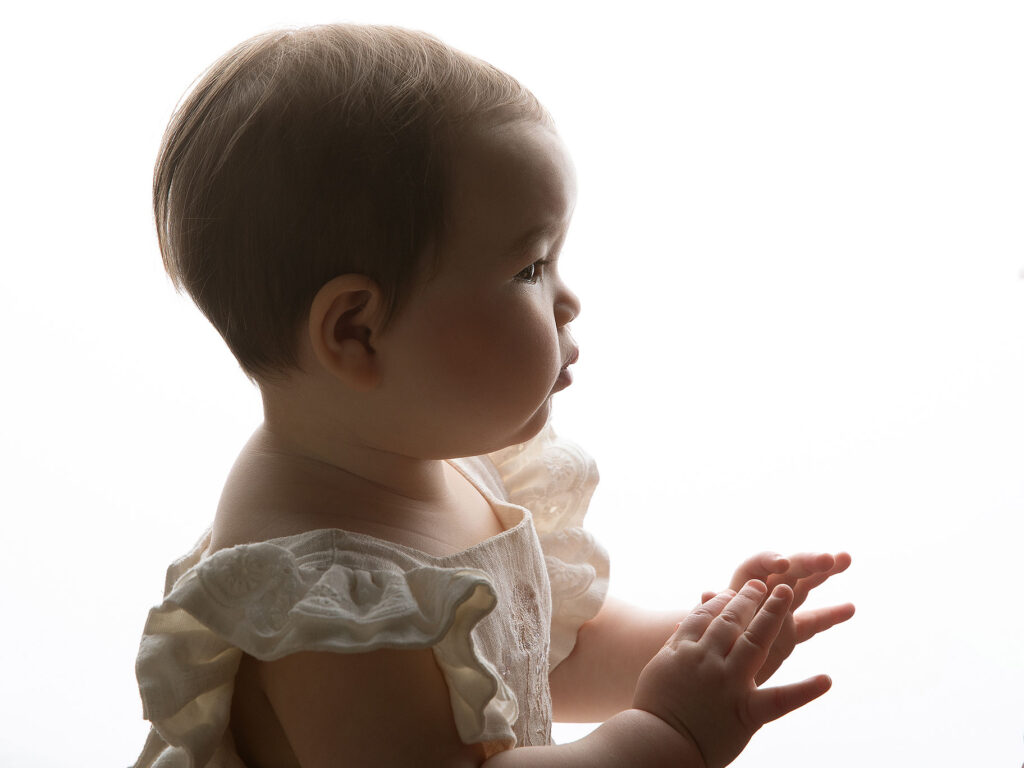 Babyansikte i profil med vit bakgrund.